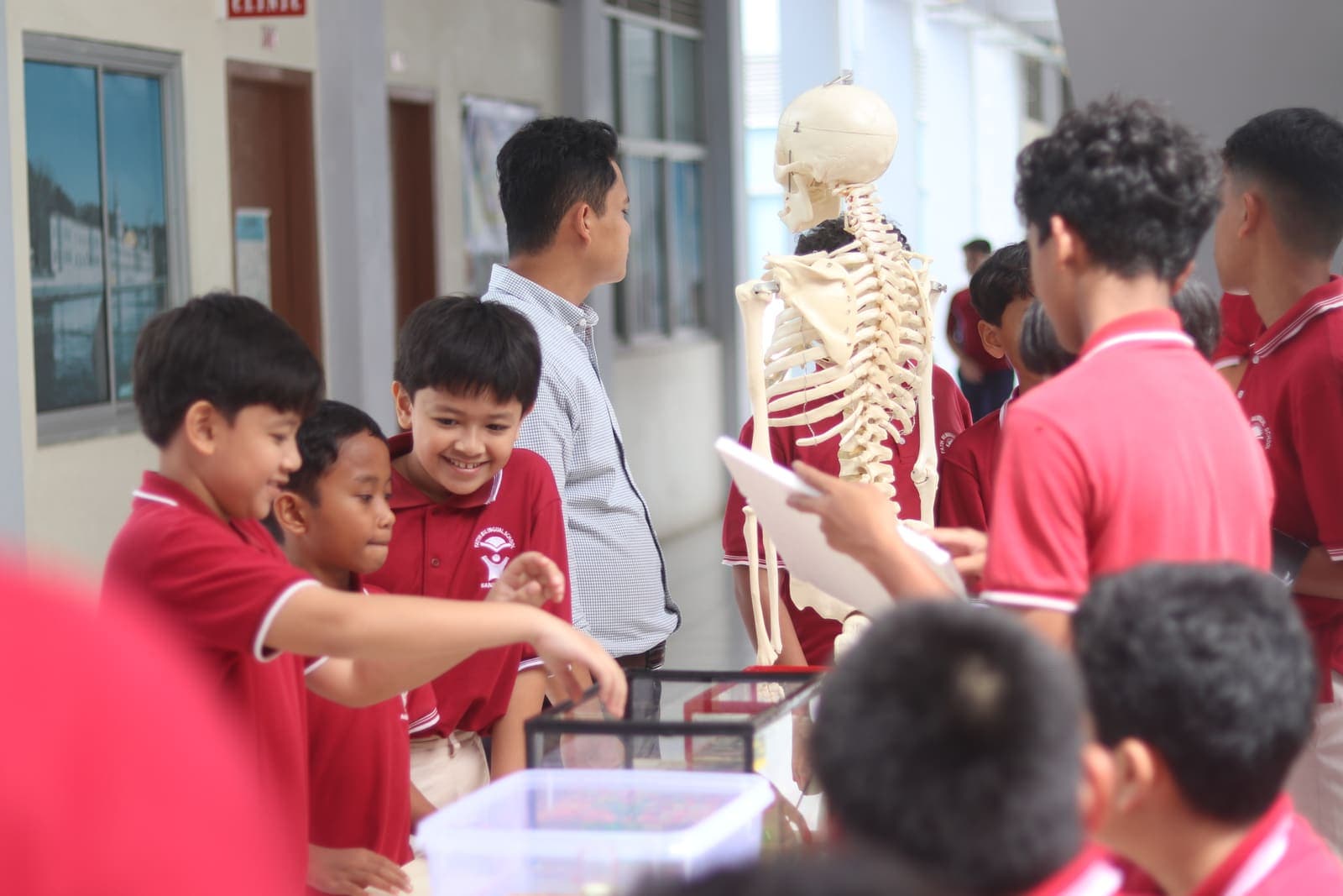 Students smiling at a hands-on science display